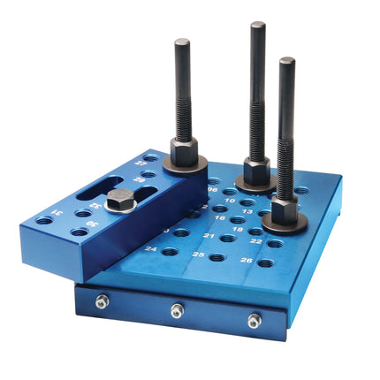A blue universal press block with adjustable height anvil bolts and a safety alignment bracket, used for pressing bearings on suspension arms.