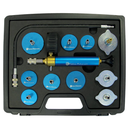 A cooling system pressure test kit with blue and silver components, including pressure caps, a high capacity metal bodied hand pump, and a quick-connect hose assembly, mounted in a black case.