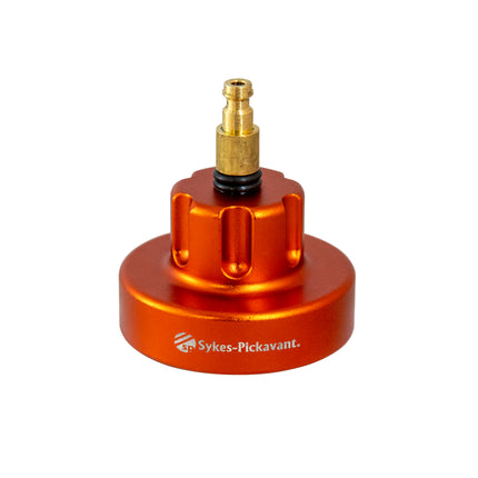 An orange metal cooling cap adaptor with a brass connector for vehicle cooling systems.